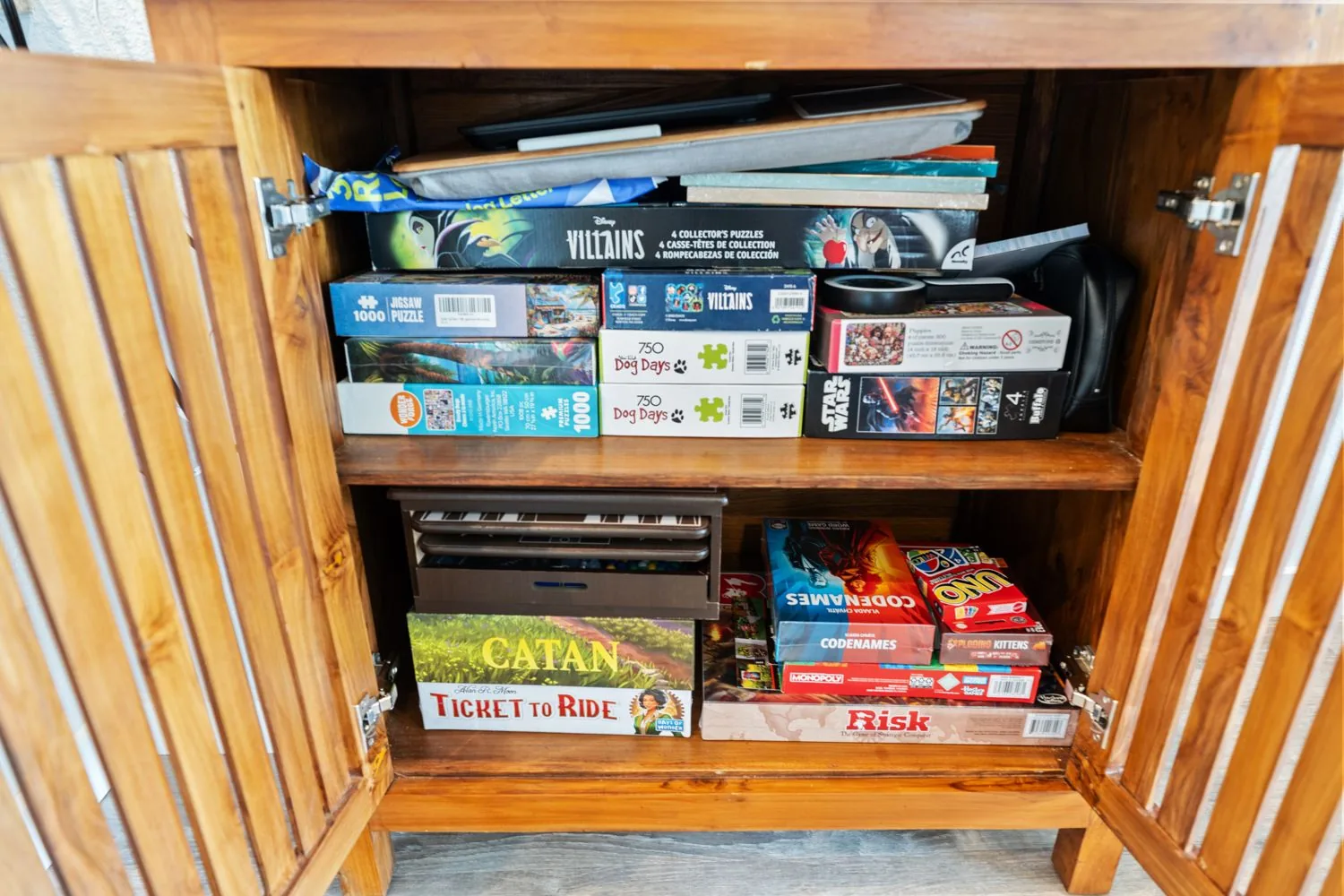 Cabinet stocked with board games and puzzles