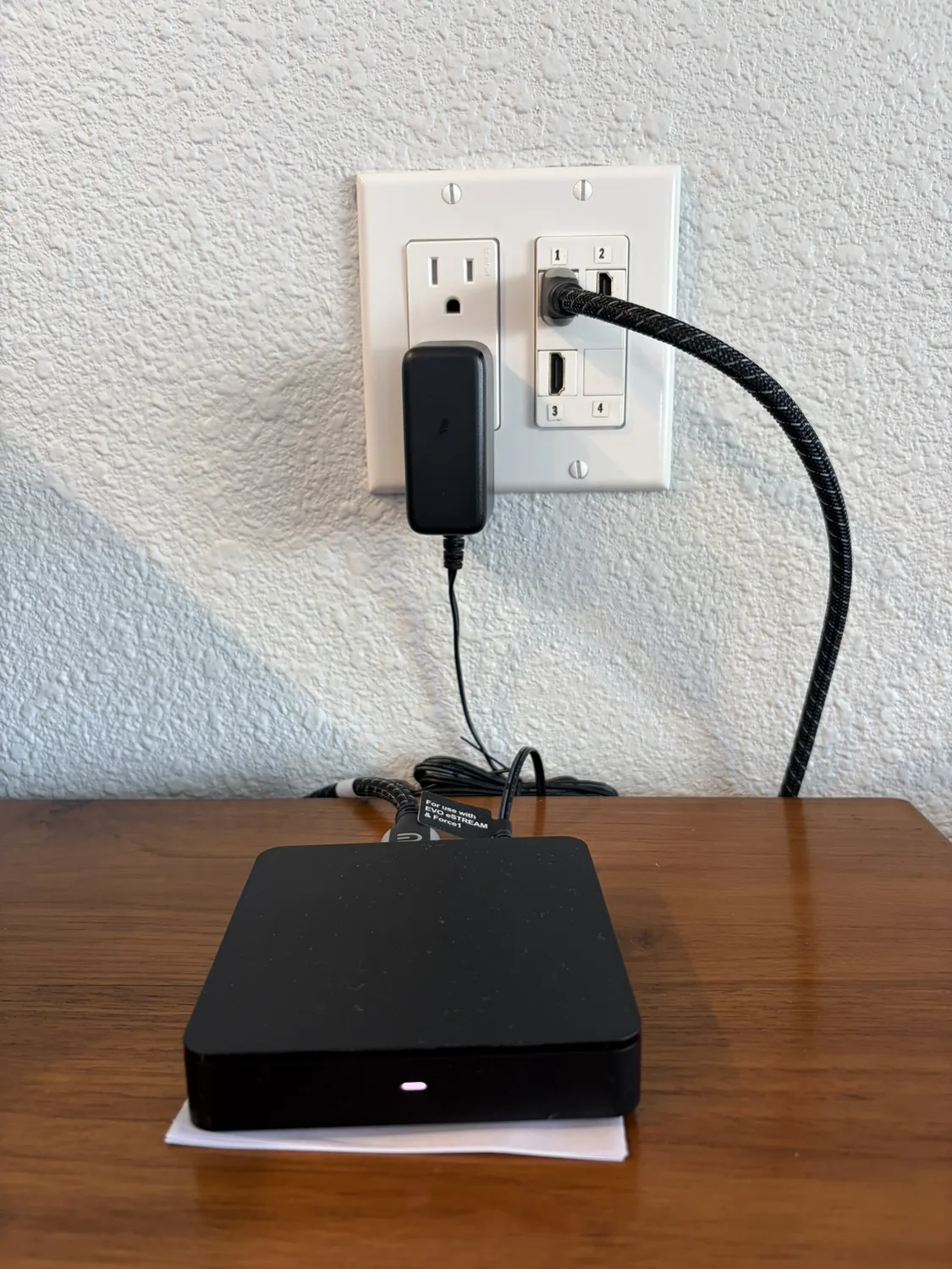 In-wall HDMI wall plate and power outlet for a guest streaming box — plug in your own device