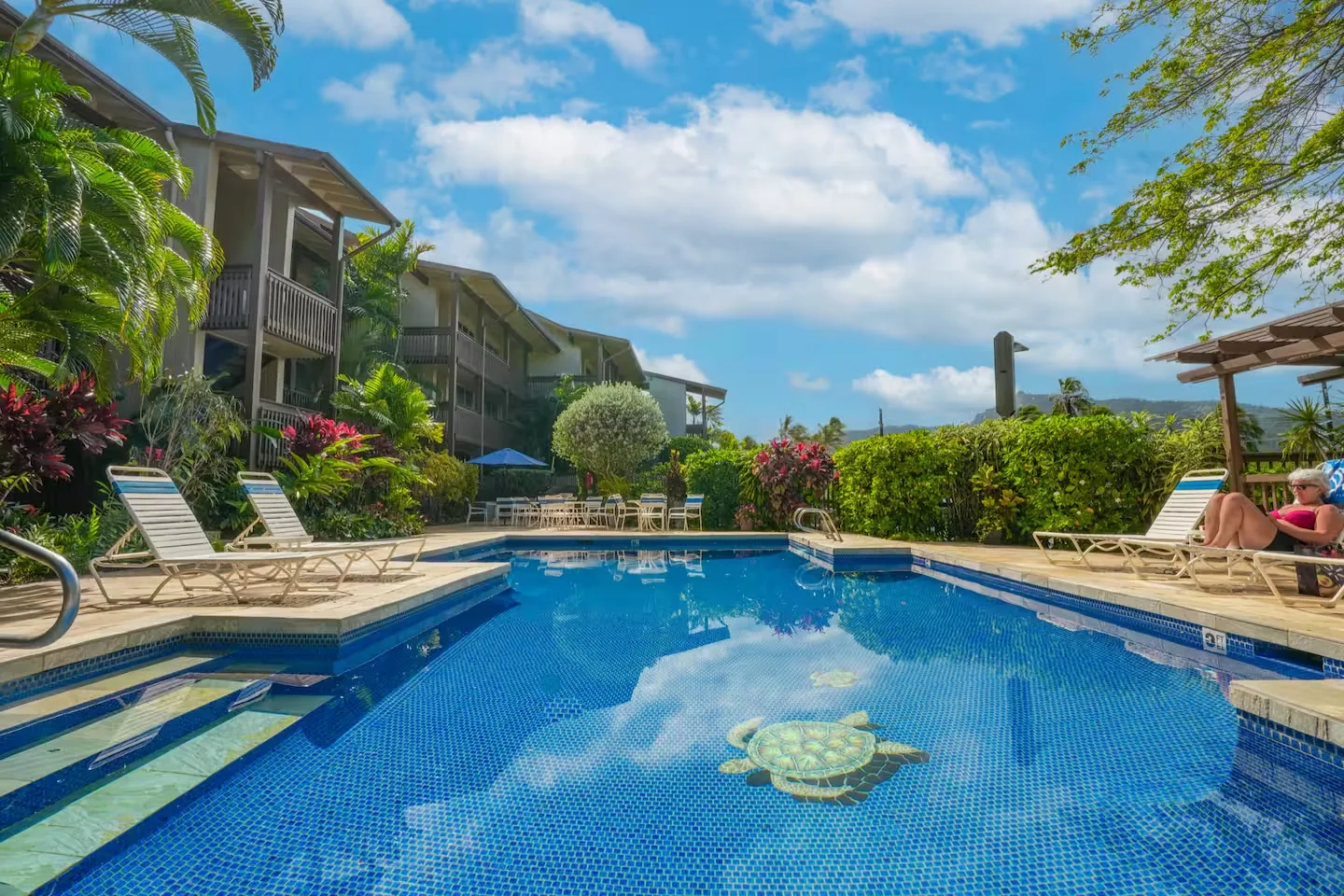 Poolside at Wailua Bay View — pool, lounge chairs, and tropical plantings